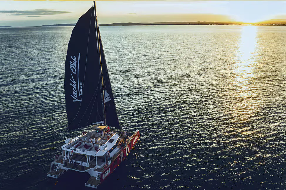 catamarán navegando al atardecer en la costa de la Camarga, cerca de Aigues-Mortes.