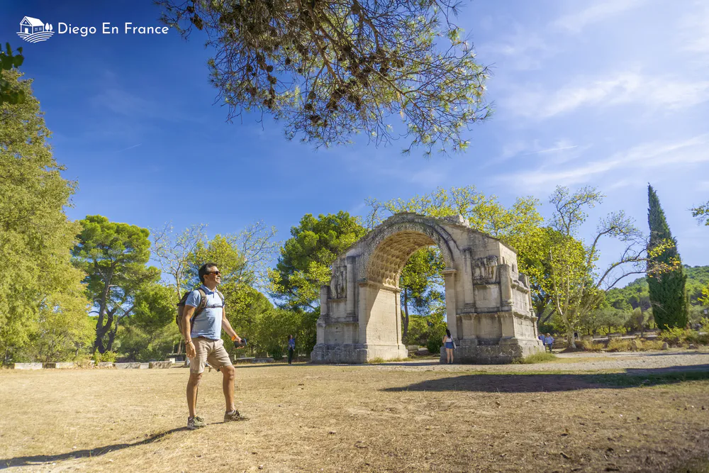 Fotografía de diegoenfrance.com de un viajero junto al arco romano, uno de los monumentos más fotogénicos del turismo local.