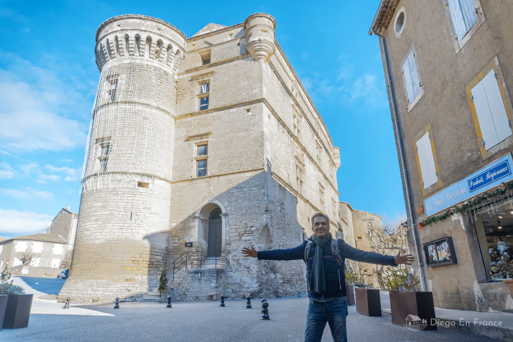 Gordes Castle, a historic 11th century fortress in the heart of the village, with a visitor enjoying the medieval atmosphere.