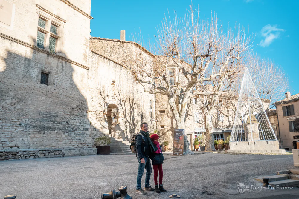 Visitors exploring the historic Gordes castle square, a medieval landmark in the heart of Provence.