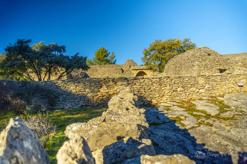 Panoramic view of the Village des Bories in Gordes, Provence, a collection of old dry stone buildings surrounded by nature.