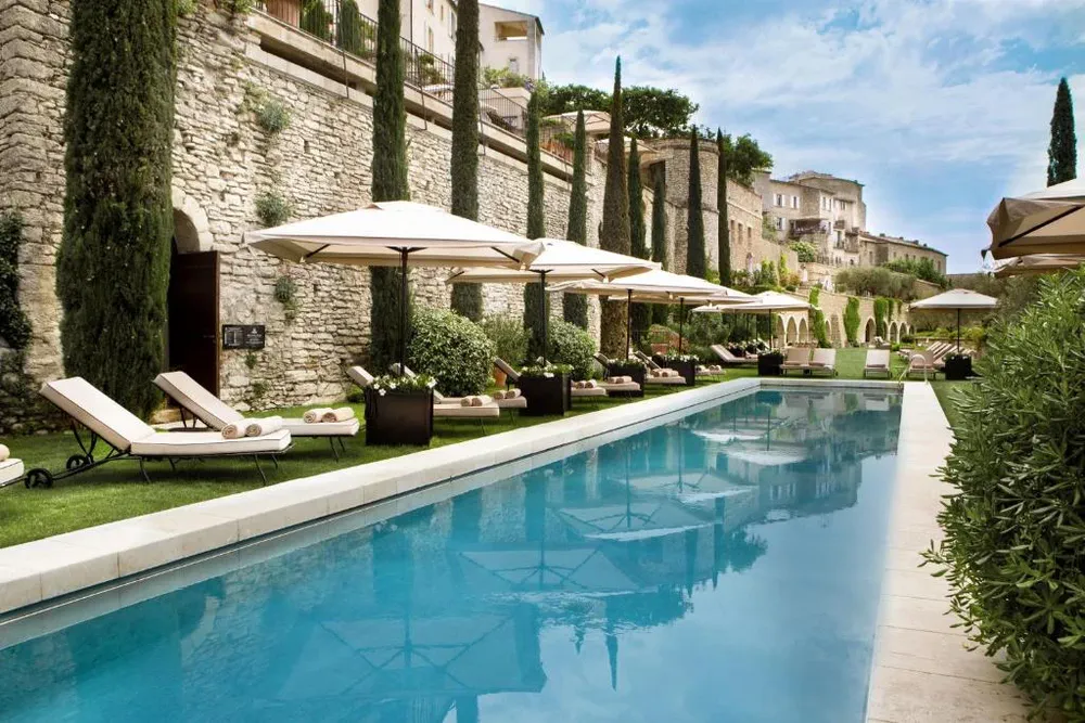 Swimming pool of Airelles Gordes, luxury hotel in stone overlooking the Luberon