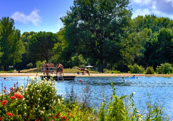 Children and adults enjoying the lake beach near Castelnau-de-Montmiral, ideal for the summer