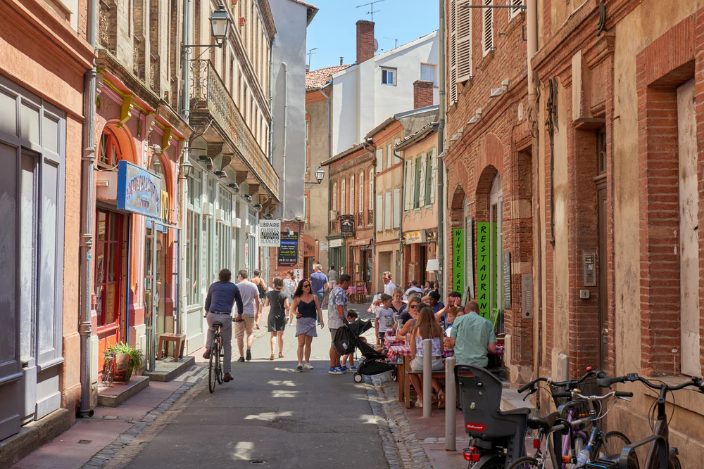 Carmes Toulouse neighborhood, cobblestone streets and local stores in the Ville Rose
