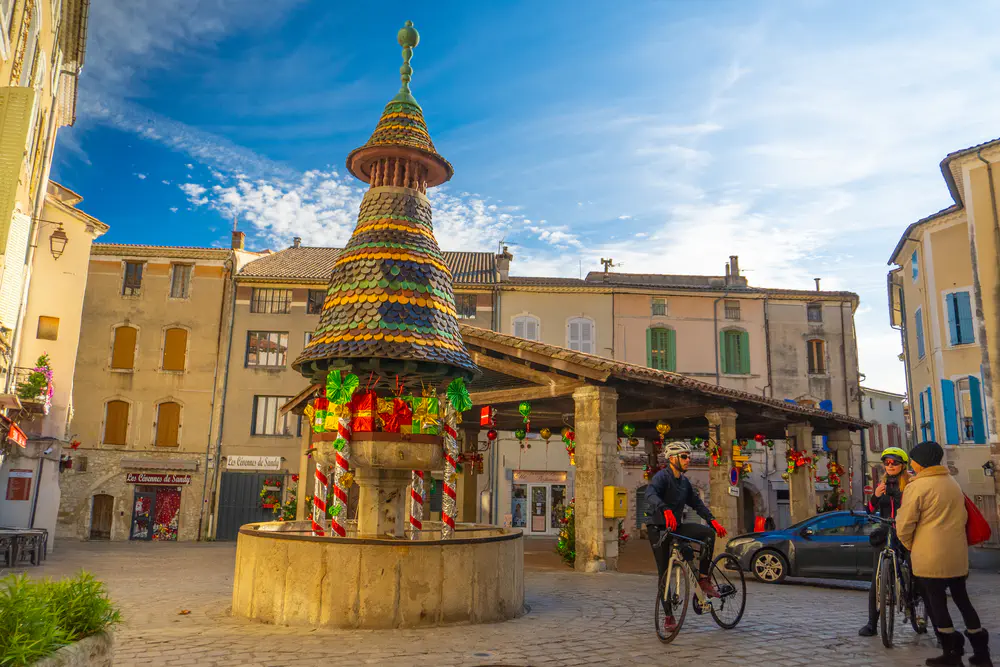 Decorated structure next to a covered market in a square in a village in the south of France