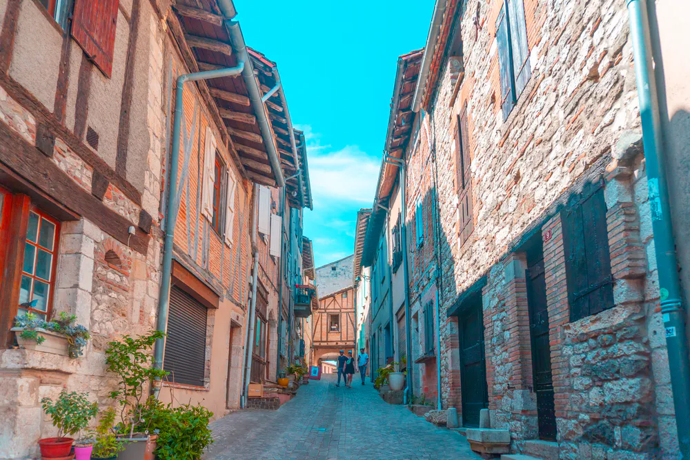 View of cobblestone street and historic houses in the old town of Castelnau-de-Montmiral