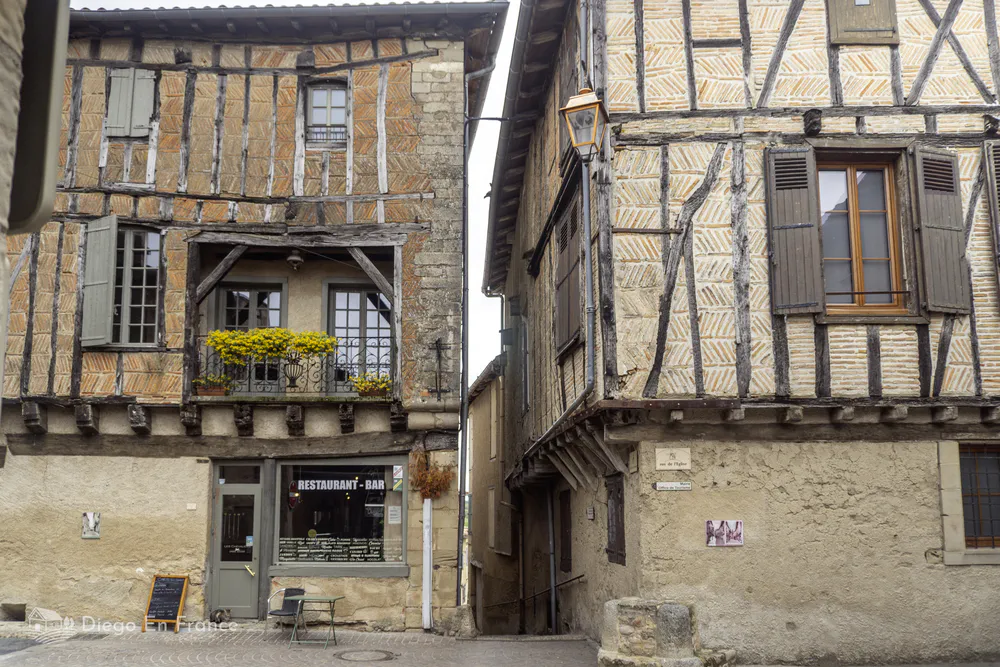 Half-timbered houses facing a narrow street in a historic village in southern France