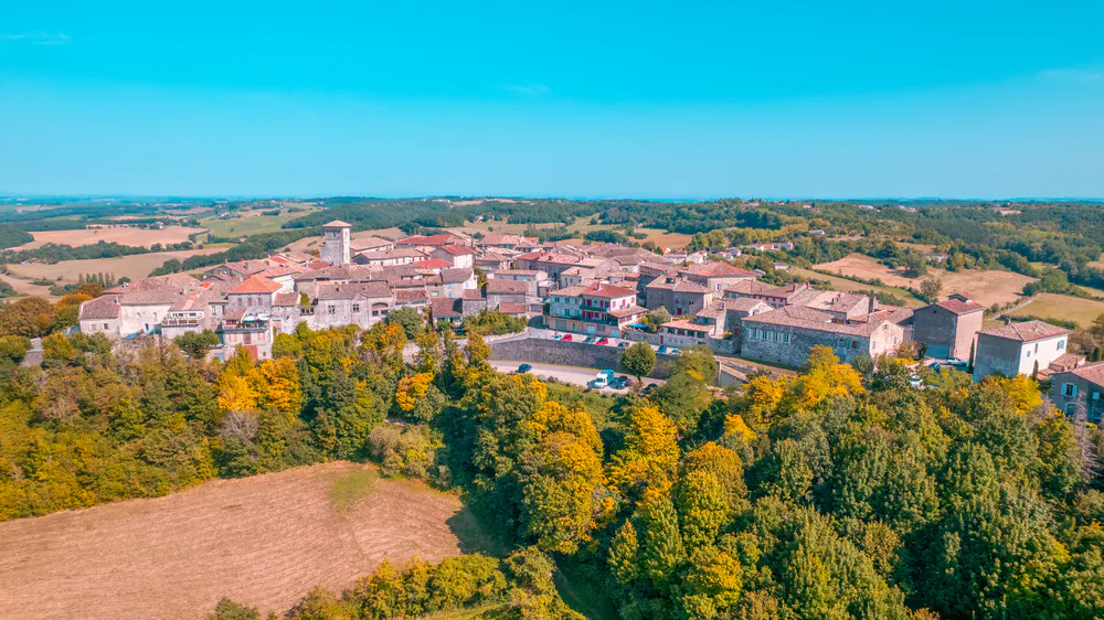 Panoramic view of the village of Castelnau-de-Montmiral from the sky, a rural and picturesque enclave.