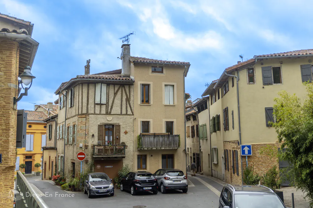 Occitan style half-timbered houses with red tiles in a quiet street in Lavaur.