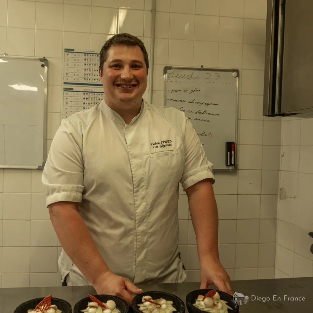 Photo by diegoenfrance.com of chef Cédric Stutz preparing the dishes at Les Glycines restaurant.